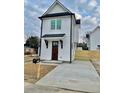 Charming two-story home with white siding, black trim, and a well-maintained front yard at 2035 Beech Ave, North Charleston, SC 29405