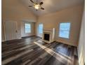 Bright living room featuring a fireplace, wood flooring, and natural light from multiple windows at 204 Tyner Trl, Summerville, SC 29486