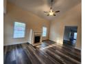 Inviting living room with a fireplace, high ceilings, and modern wood-look floors at 204 Tyner Trl, Summerville, SC 29486