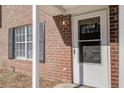 Close-up of a brick townhome with white trim and a glass-paneled door at 205 Weber Rd # B, Summerville, SC 29483