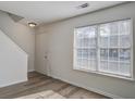 Living room with wood-look flooring, white walls, and a staircase at 205 Weber Rd # B, Summerville, SC 29483