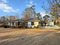 Well-maintained single-story home with a mix of brick and siding, complemented by a spacious yard and tidy landscaping at 209 E 4Th S St, Summerville, SC 29483