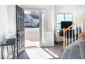 Bright foyer with wood floors, open staircase, and a view of the home's exterior at 215 Evesham Dr, Summerville, SC 29485