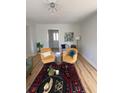Sun-filled living room with hardwood floors, area rug, a modern sofa and stylish chairs at 222 Braly Dr, Summerville, SC 29485