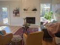 Cozy living room with a brick fireplace, modern decor, and lots of natural light at 222 Braly Dr, Summerville, SC 29485