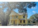 Two-story home with yellow siding and a second-story balcony at 2982 Lodge Berry Ln, Johns Island, SC 29455