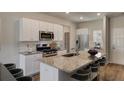 Modern kitchen features granite countertops, stainless appliances, and a center island at 304 Pine Crest View Dr, Summerville, SC 29486