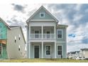 Charming two-story home featuring light green siding, white trim and a cozy second story balcony at 306 O'Malley Dr, Summerville, SC 29483
