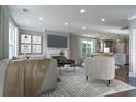Cozy living room with fireplace, dark wood floors, recessed lighting and neutral colored modern furniture at 306 O'Malley Dr, Summerville, SC 29483