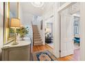 Sunlit foyer features wood floors, an elegant console, and access to the living room at 32 Tradd St, Charleston, SC 29401