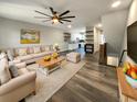 Open-concept living room with hardwood floors, bright light, and modern furnishings at 4666 Palm View Cir, North Charleston, SC 29418