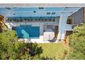 Aerial view showcasing a private backyard pool, outdoor lounge area, deck and lush landscaping at 74 Sandbar Ln, Folly Beach, SC 29439