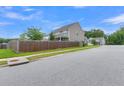 Fenced backyard with green lawn, offering privacy and space for outdoor activities at 9998 Winged Elm St, Ladson, SC 29456