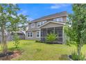 A spacious backyard featuring a screened-in porch perfect for outdoor relaxation at 9998 Winged Elm St, Ladson, SC 29456