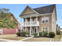 Charming two-story home with a brick facade, welcoming front porch, and a well-maintained landscaped yard at 109 Pavilion St, Summerville, SC 29483