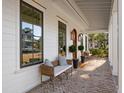 Inviting front porch with brick flooring and comfortable seating, great for relaxing at 1119 Simmons St, Mount Pleasant, SC 29464