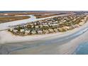 An aerial view of a beautiful coastal community featuring oceanfront homes and sandy beaches at 112 Ocean Blvd, Isle of Palms, SC 29451