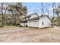Well-maintained two-story home with a wrap-around porch and a two-car garage, nestled on a spacious lot at 135 Rapture Ln, Wando, SC 29492