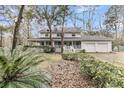 Traditional two-story home featuring a welcoming wrap-around porch and a convenient two-car garage at 135 Rapture Ln, Wando, SC 29492