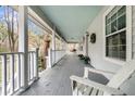 Inviting wrap-around porch with classic white railings, offering an ideal spot for relaxing at 135 Rapture Ln, Wando, SC 29492