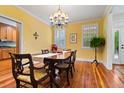 Elegant dining room featuring hardwood floors, a stylish chandelier, and natural light at 140 Old Plantation Ln, Moncks Corner, SC 29461