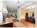 Inviting living area flows into dining space, showcasing hardwood floors, neutral tones, and ample natural light at 140 Old Plantation Ln, Moncks Corner, SC 29461