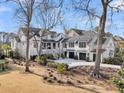 Stunning white modern farmhouse with an attached garage, lush landscaping and circular driveway at 151 Brailsford St, Charleston, SC 29492