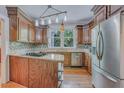 Charming kitchen with custom wood cabinets, granite countertops, and stainless steel appliances at 1860 Pinopolis Rd, Pinopolis, SC 29469