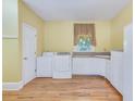Spacious laundry room with washer, dryer, ample counter space, and a window at 1860 Pinopolis Rd, Pinopolis, SC 29469