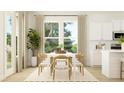 Inviting dining area with white table, six chairs, hardwood floors and lots of natural light at 214 Denham St, Summerville, SC 29486