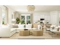 Bright living room features a white sofa, modern chairs, and neutral textures under a chandelier at 214 Denham St, Summerville, SC 29486
