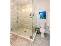 Elegant bathroom featuring a glass-enclosed shower, modern fixtures, and decorative tile work, with complementary artwork and accessories at 22 1/2 Mary St # A B C, Charleston, SC 29403
