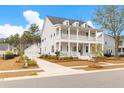 Beautiful home with a double porch, long driveway, and a detached garage for extra parking and storage at 3587 Clambank Dr, Mount Pleasant, SC 29466