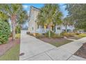 Lovely two-story yellow home featuring palm trees, a front porch and a driveway leading to a garage at 3713 Maidstone Dr, Mount Pleasant, SC 29466
