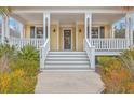 Inviting front porch with white railings and detailed trim, leading to the front door of a charming home at 3713 Maidstone Dr, Mount Pleasant, SC 29466