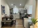 Eat-in kitchen featuring white cabinets, stainless steel appliances, and modern finishes at 5110 Temple St, North Charleston, SC 29405