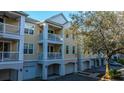 Townhome exterior showcasing garage parking and private balconies at 60 Fenwick Hall Allee # 234, Johns Island, SC 29455