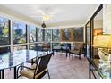 Relaxing sunroom with large windows, tile flooring, and comfortable seating at 796 Summerwind Cir, Edisto Beach, SC 29438