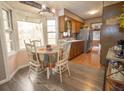Eat-in kitchen featuring stainless steel appliances, wood cabinets, a bay window, and wood-look floors at 8020 Nantuckett Ave, North Charleston, SC 29420