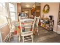 Eat-in kitchen featuring stainless steel appliances, wood cabinets, a bay window, and wood-look floors at 8020 Nantuckett Ave, North Charleston, SC 29420