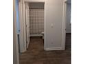 Clean bathroom featuring a shower with neutral curtain, toilet, and hardwood floors at 911 Woodside Creek Ln, Summerville, SC 29486