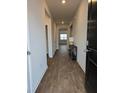 Inviting entry hallway featuring hardwood floors, neutral paint, and classic design at 911 Woodside Creek Ln, Summerville, SC 29486