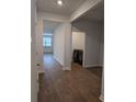 Open hallway with hardwood floors leading to the living area and laundry room at 911 Woodside Creek Ln, Summerville, SC 29486