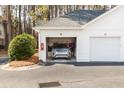 Two-car garage showcasing a parked silver SUV, with a fire extinguisher and a neat bush near the driveway at 1025 Riverland Woods Pl # 608, Charleston, SC 29412