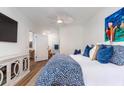 Stylishly decorated bedroom with bright walls, a ceiling fan, television, and connected bathroom and kitchen at 1025 Riverland Woods Pl # 608, Charleston, SC 29412