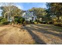 Traditional home with a well-manicured lawn and garden, with mature trees providing shade and character at 114 Colleton Ave, Summerville, SC 29483