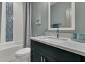 Stylish bathroom with modern vanity, sleek fixtures, and a tub with blue mosaic tiles at 1184 Reserve Ln, Awendaw, SC 29429