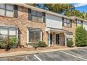 Inviting two-story townhouse with brick facade, black shutters, well-maintained landscaping, and dedicated parking spaces at 1910 Tropicana Rd # 9-D, North Charleston, SC 29406