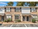 Inviting two-story townhouse with brick facade, black shutters, well-maintained landscaping, and dedicated parking spaces at 1910 Tropicana Rd # 9-D, North Charleston, SC 29406
