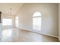 Bright living room boasting beautiful hardwood floors, high ceilings, and large arched windows at 204 Candleberry Cir, Goose Creek, SC 29445